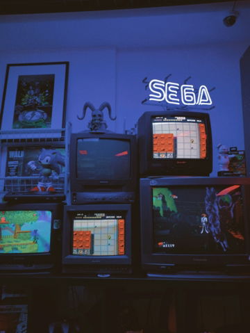black crt tv on brown wooden tv rack